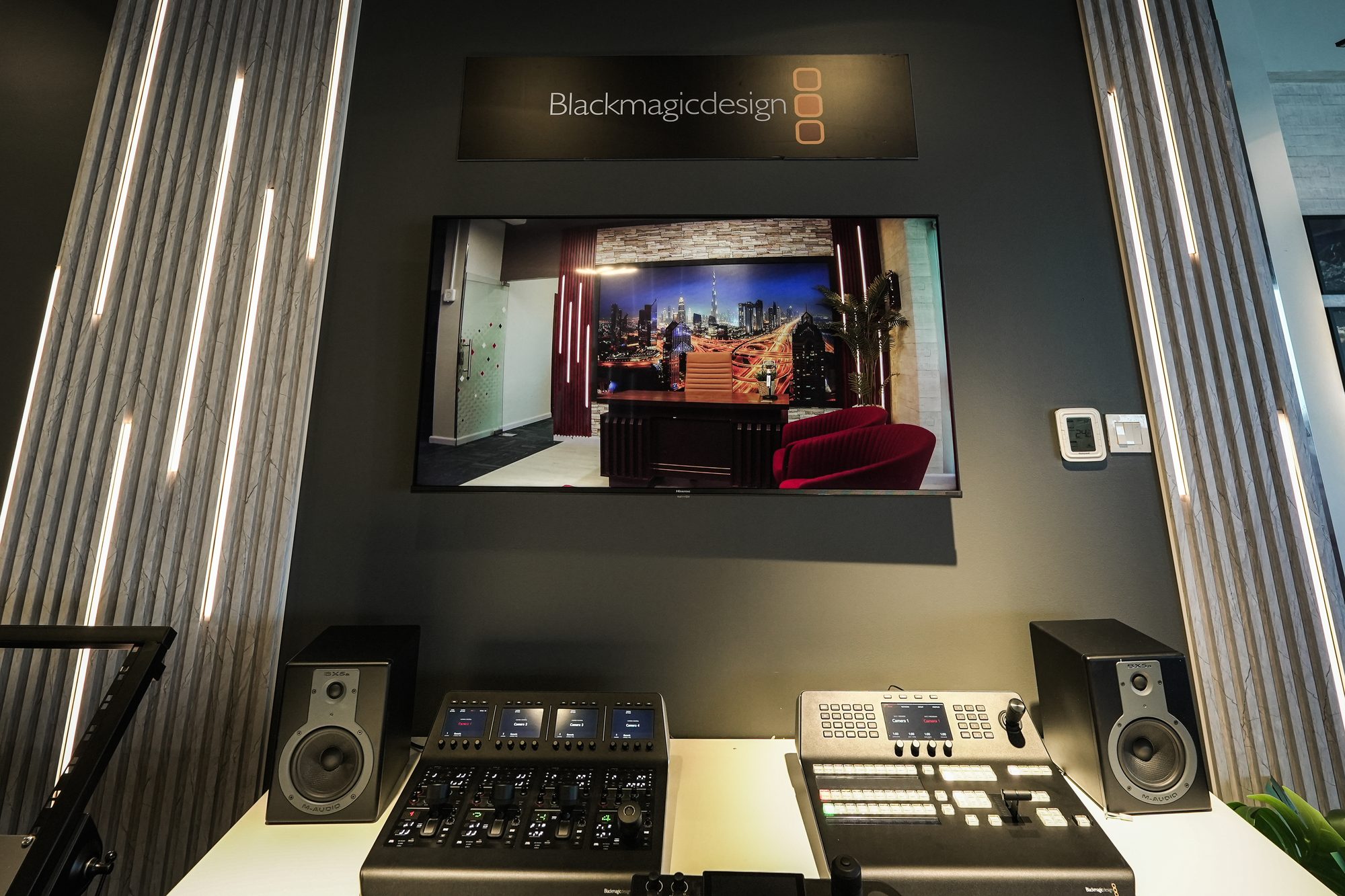 The Blackmagic Design wall, two control desks below the programme screen
