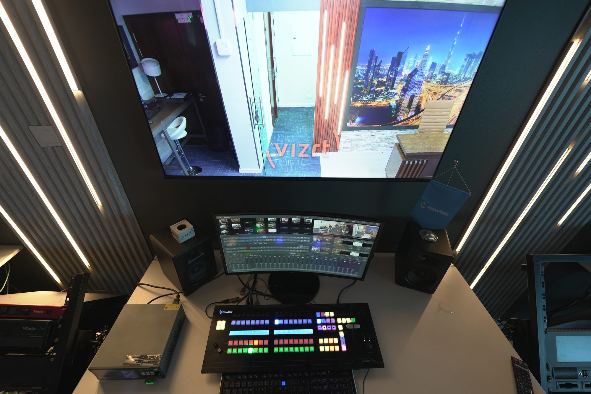 The MCX gallery desk from above, multiview and switcher panel with the racks either side