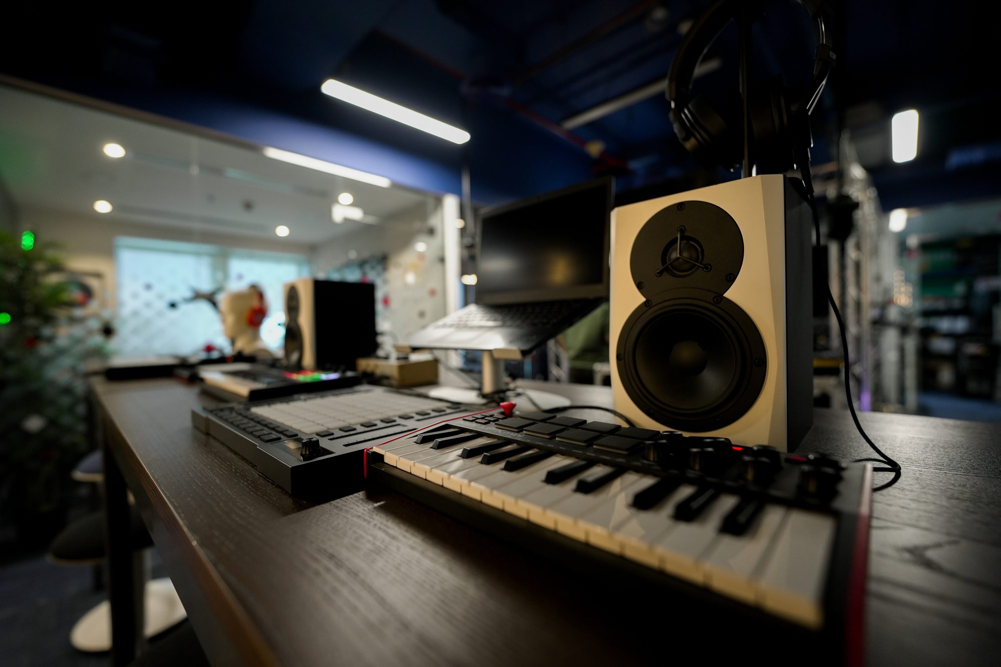 Keyboard controller and near-field monitor at an MCX music production desk