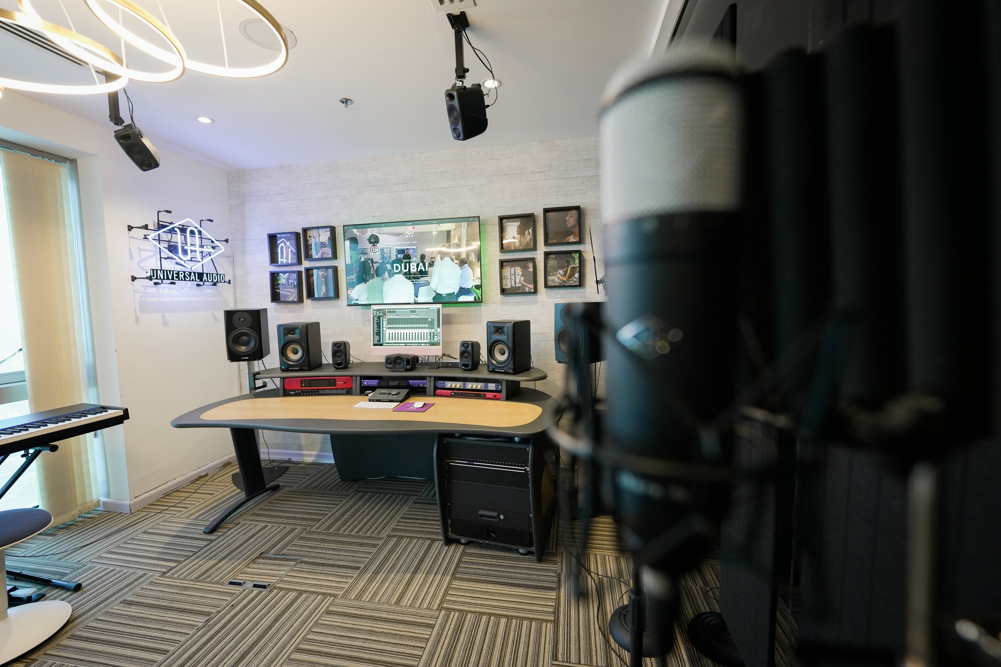The recording room, monitors and outboard on the bench, a large-diaphragm microphone in the foreground