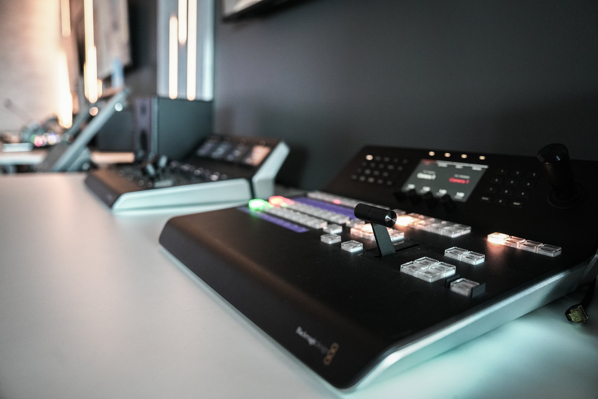 The switcher panel at MCX, keys lit in the low light of the gallery