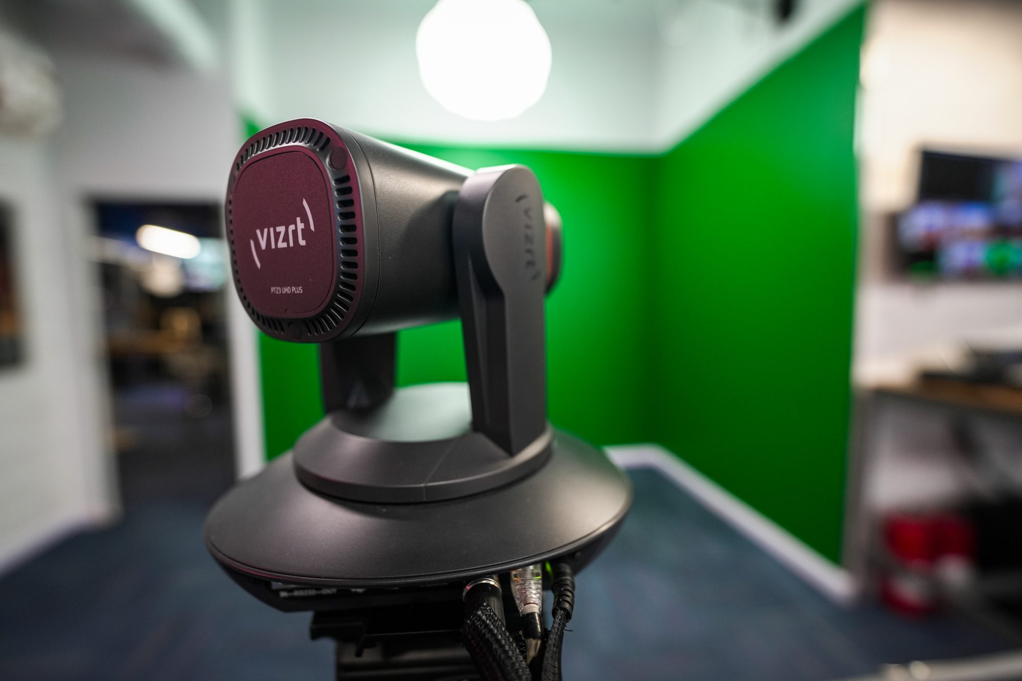 A Vizrt PTZ camera head against the green screen