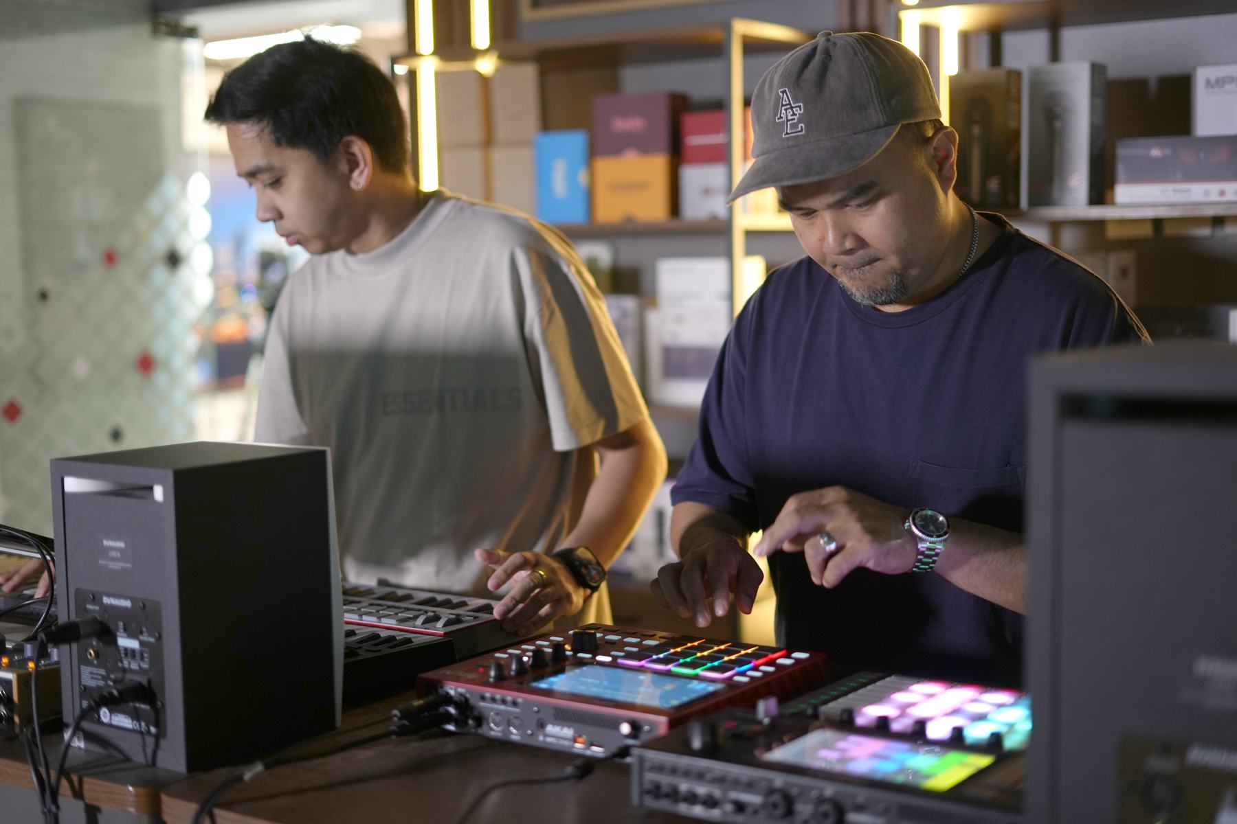 Two producers working together at the MCX music bench